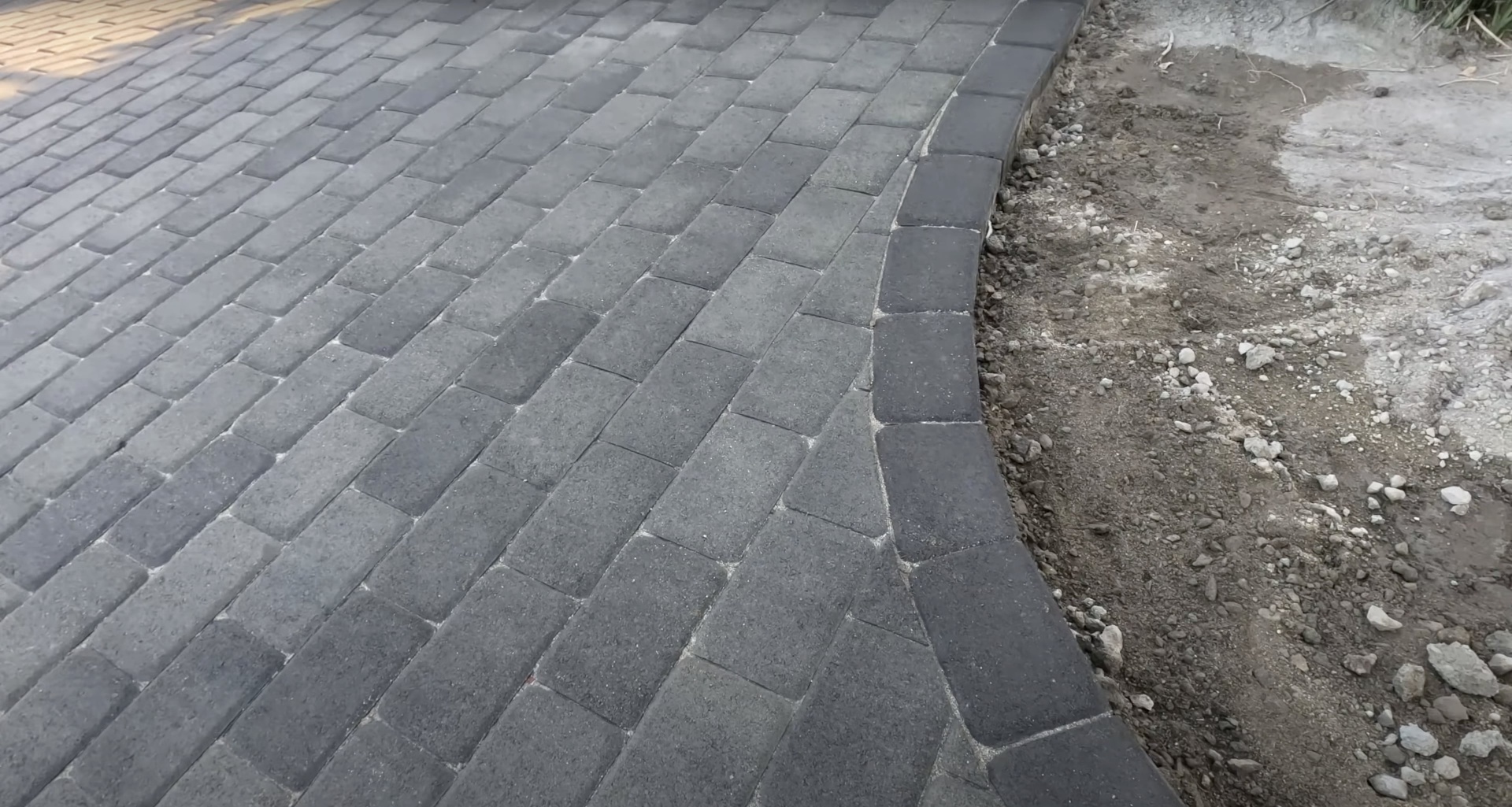 Precision concrete paver installation showing detailed pattern work