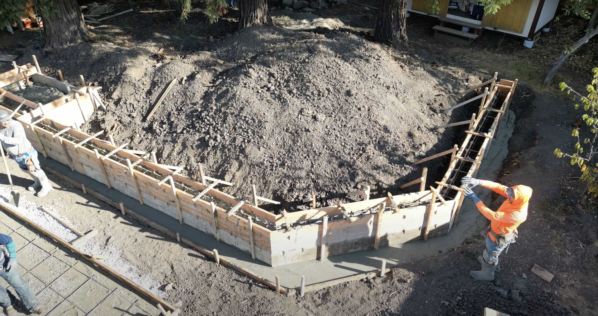 Concrete foundation preparation with wooden forms and reinforcement ready for pour