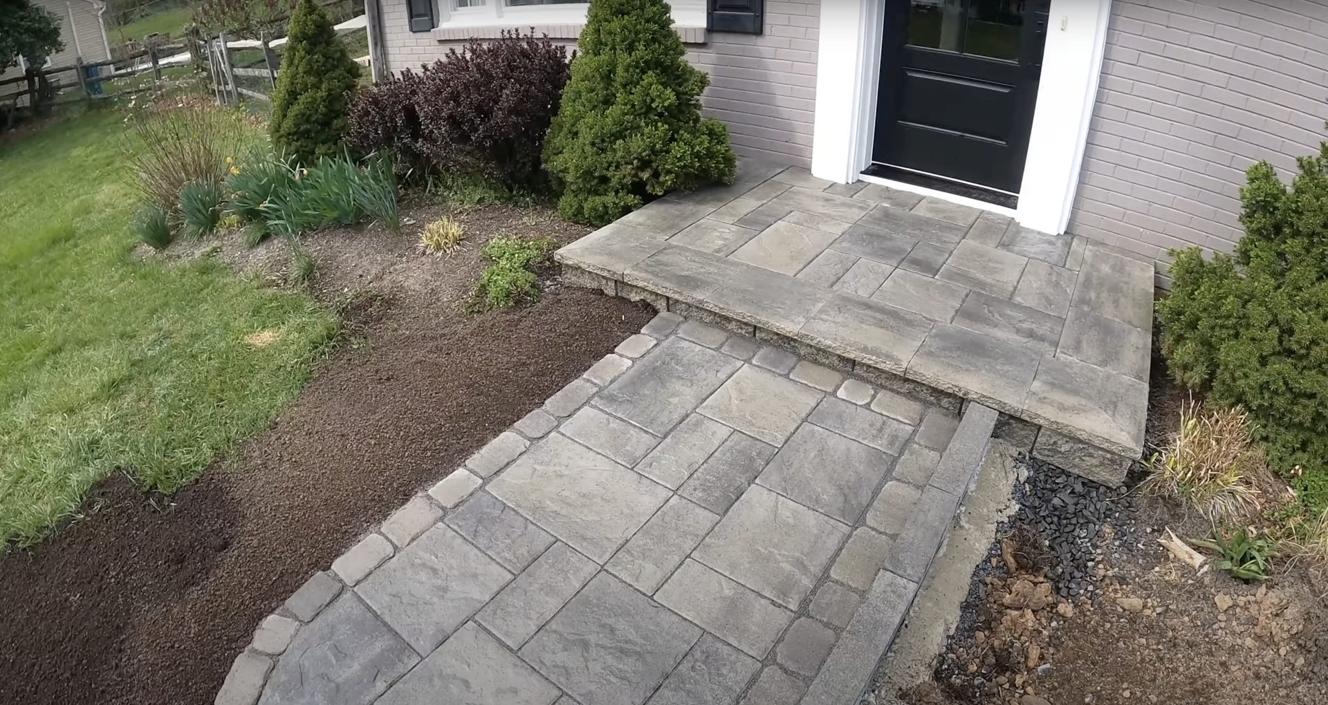 Stamped concrete entrance steps and walkway with natural stone pattern
