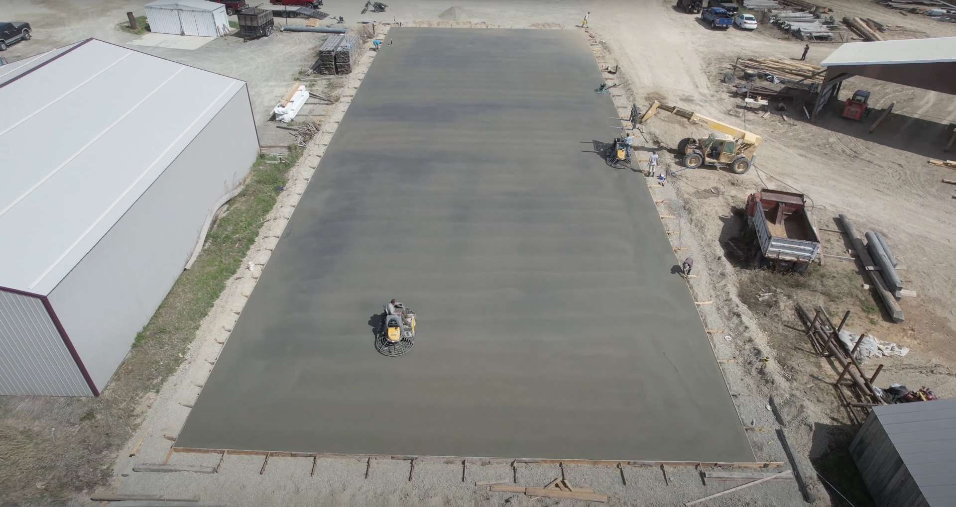 Large commercial concrete slab being finished with professional equipment