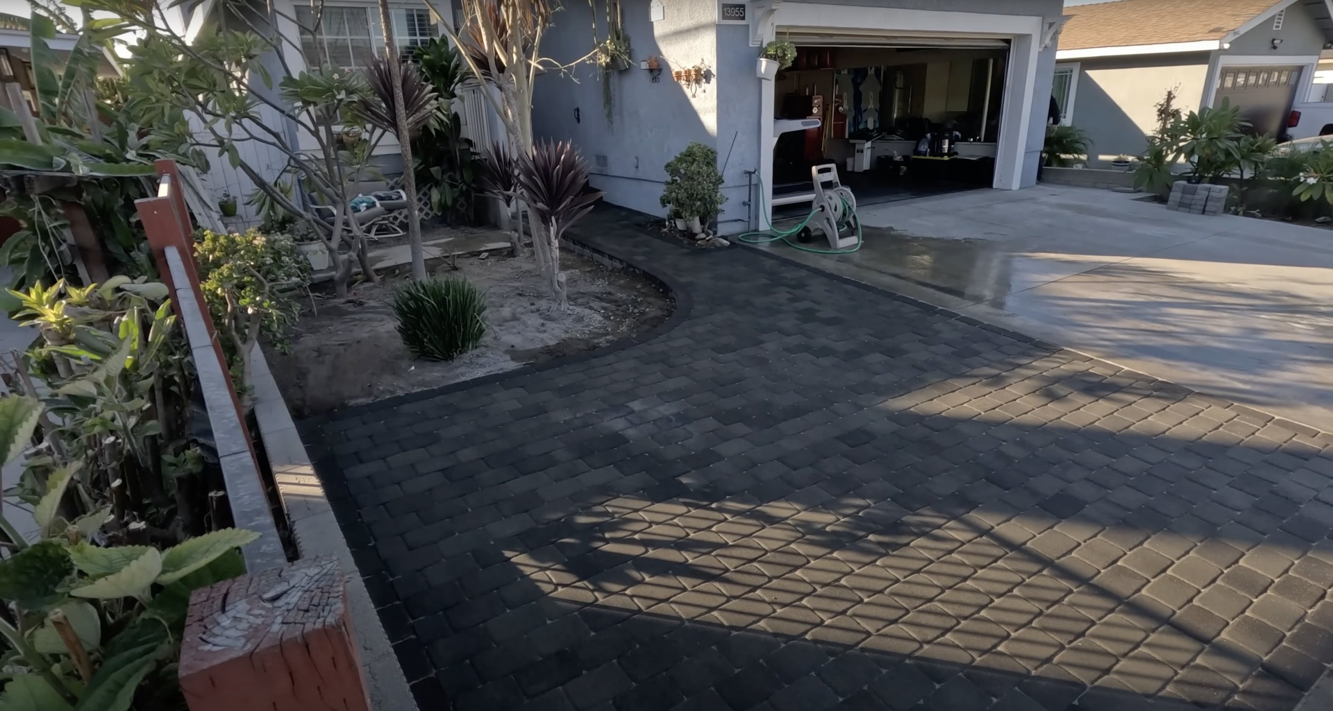 Elegant stamped concrete driveway with decorative patterns and professional edging
