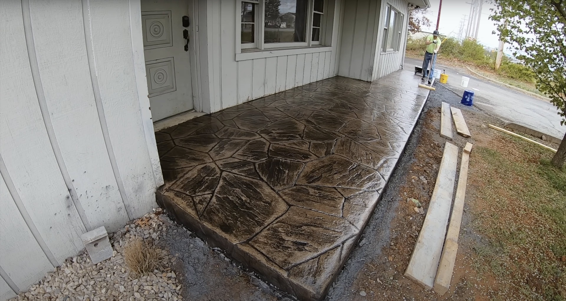Professional concrete driveway installation showing stamped pattern and quality finish
