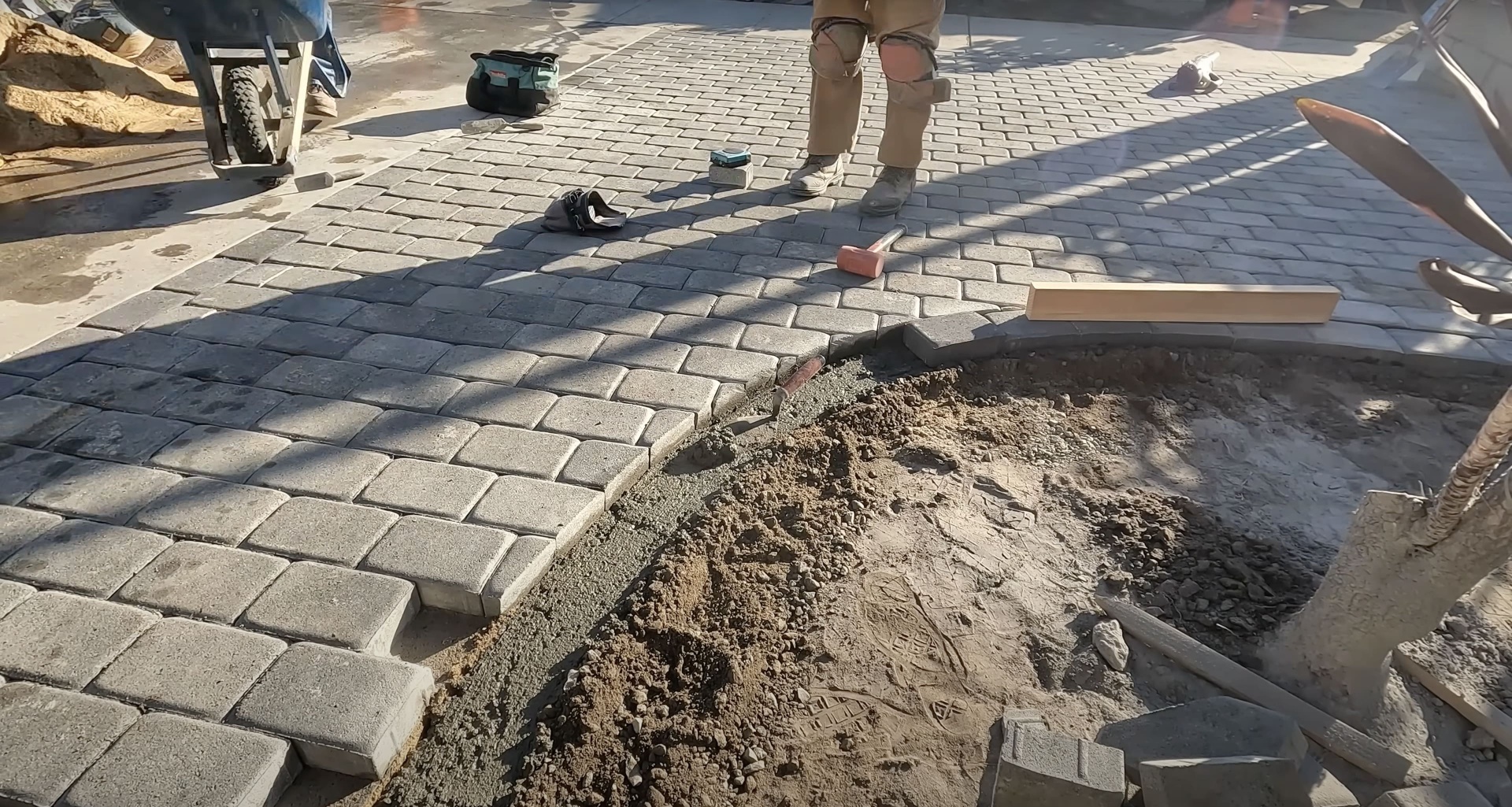 Concrete paver installation in progress showing skilled craftsmanship